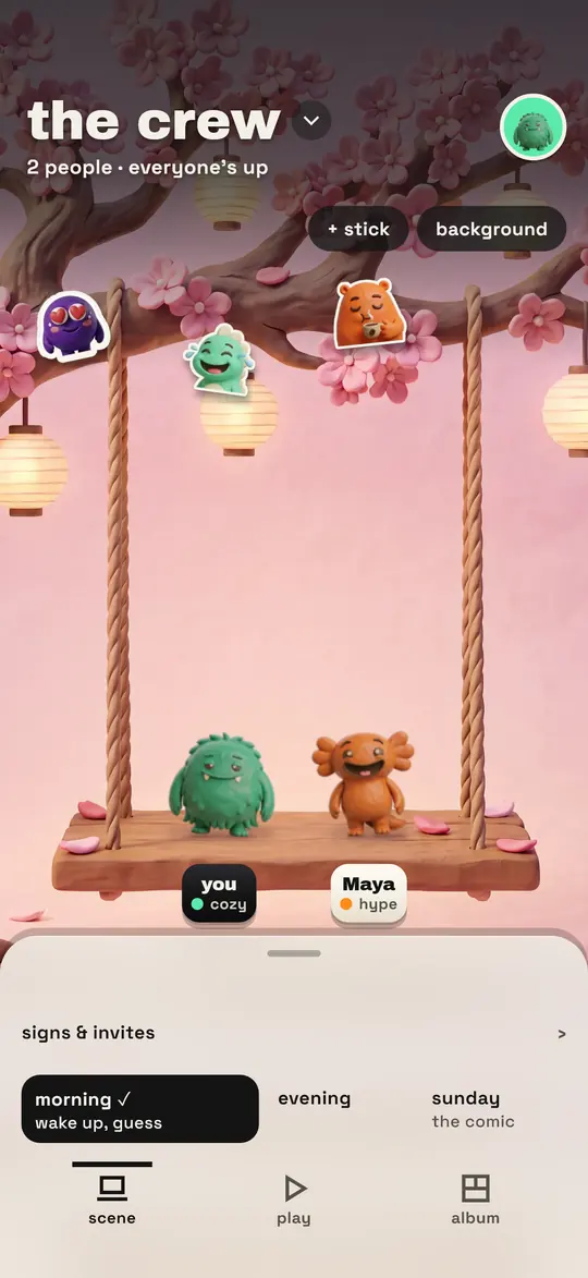 The group screen on the cherry tree swing wall: two clay monsters sitting on a wooden swing under pink blossoms and paper lanterns.